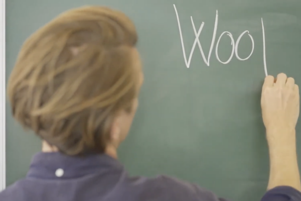 PHOTO - WOOF - External - Origin Story - Mathias at chalkboard